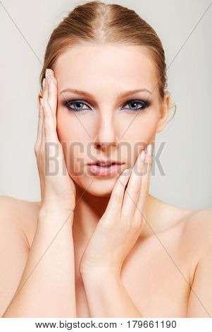 Attractive blonde topless woman with dark eye make up