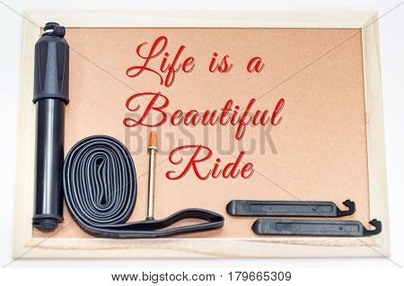 Bicycle inspirational and encouraging quote,Life is a beautiful ride with mini bike pump with presta & schrader valve compatibles,multifunction bicycle mechanic fix tools set tools allen keys,inner tube & tire patch levers on white background