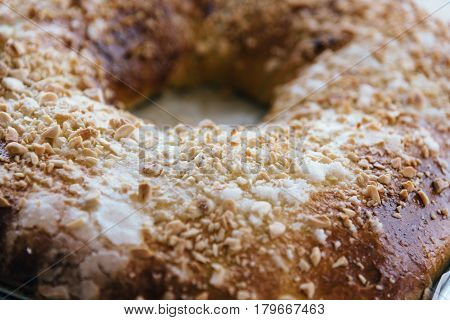 Close Up Of of sweet bread ringed dessert with sugar and almonds. On oven plate Called roscon is typical in spanish cuisine. Horizontal composition
