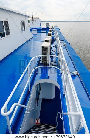 Ladder leading to captain's cabin of cruise river motor ship. Ship is moving along Uglich reservoir
