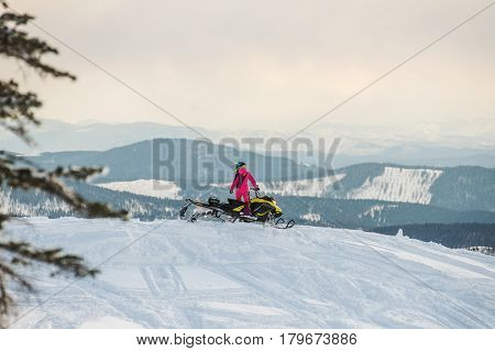 Rider on the snowmobile in the mountains ski resort in Amut Russia.