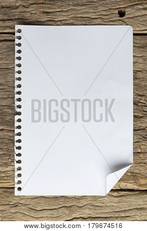 note paper on wood texture background with copy space. A blank notebook page on table wood office notebook Top view for design and background. notebook on wood. notebook on table. white notebook. notebook on woden.
