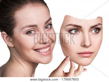 Young woman hiding hapyiness under the serious mask. Hypocritical, insincere, two-faced female