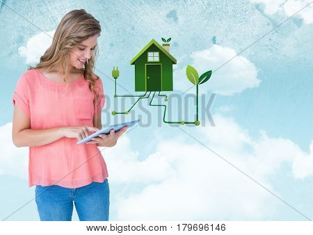 Digital composite of Woman with tablet and green house graphic against sky