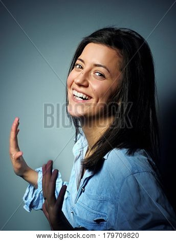 Attractive Young Woman Relax And Dance. Portrait Of Happy Girl Dancing Your Hands Up On Grey Backgro