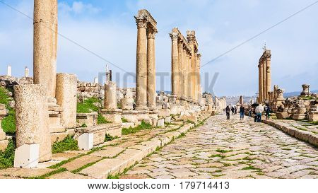 People Walk On Cardo Maximus Road In Gerasa