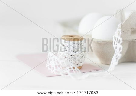 Easter eggs on wooden background with pink envelope