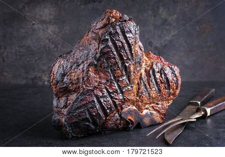 Barbecue dry aged Wagyu Bistecca alla Fiorentina as close-up on a black slate