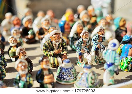 Ceramic statuettes of Uzbek men wearing in traditional costume, Itchan Kala (Xiva Ichon Qala) UNESCO world heritage, Khiva, Uzbekistan.