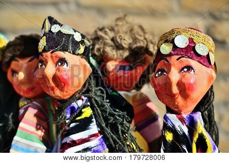 Traditional souvenir painted mashed paper (papier mache) dolls wearing in traditional costumes . Itchan Kala (Xiva Ichon Qala) UNESCO world heritage, Khiva, Uzbekistan.