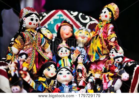 Traditional souvenir painted mashed paper (papier mache) dolls wearing in traditional costumes . Itchan Kala (Xiva Ichon Qala) UNESCO world heritage, Khiva, Uzbekistan.