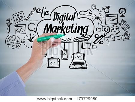 Digital composite of Hand with pen and black digital marketing doodles against grey wood panel
