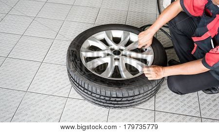 A car mechanic Inflating Tires with Nitrogen