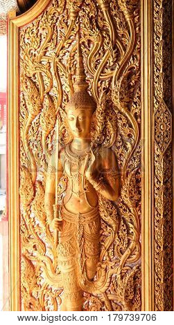 This is a picture of a beaurifully decorated door in Buddha Temple in Thailand.