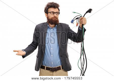 Confused guy looking at different types of electronic cables isolated on white background