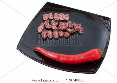 Sliced Sausage With Spices On Black Plate