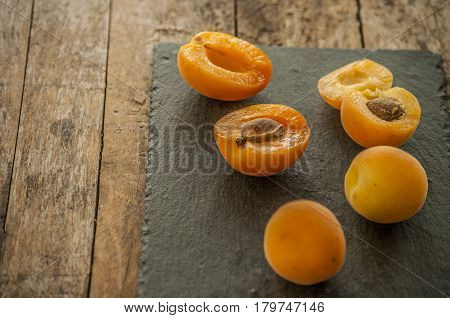sliced apricots isolated on black background close up