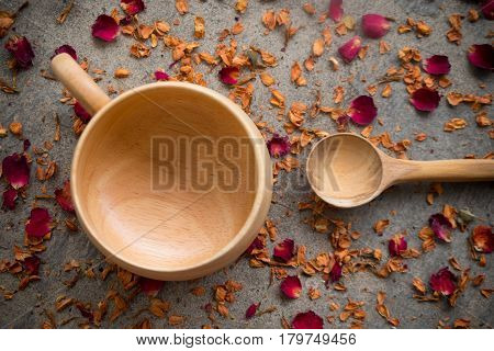 Wooden cup and spoon for hot drink cup make from wooden on dry rose petals