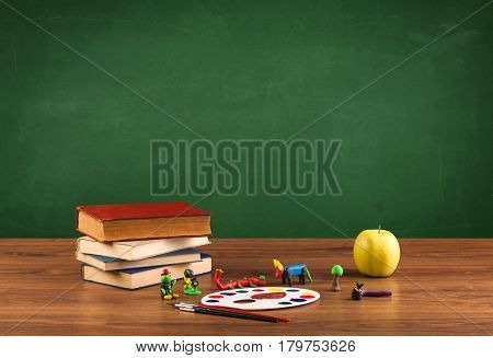 Back to school concepty with clear blackboard background, desk, items