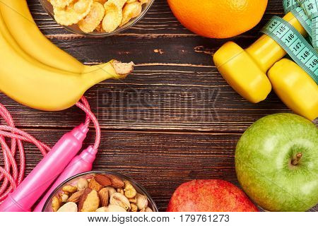 Bananas, apple and skipping rope. Healthy food and sport tools. Develop your willpower.