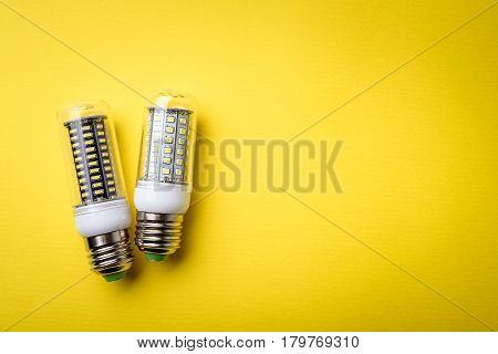 Energy Saving Led Light Bulb On A Yellow Background With Empty Space