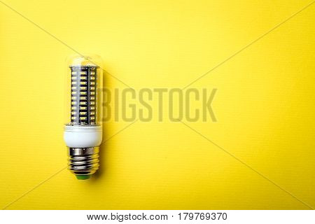 Energy Saving Led Light Bulb On A Yellow Background With Empty Space