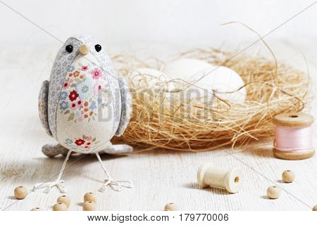 Handmade Bird Sewed From A Cloth Stands On A White Wooden Table