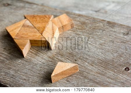 Wooden tangram puzzle wait to fulfill home shape for build dream home or happy life concept