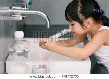 A sick asian children Saline nasal wash