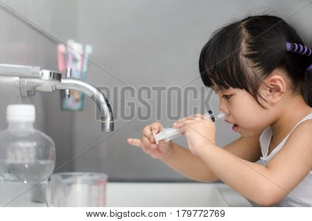 A sick asian children Saline nasal wash