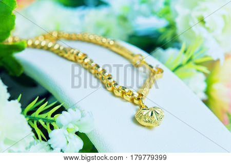Gold Necklace 96.5 Percent Thai Gold Grade With Gold Heart Pendant And Flowers Putting On White Clot