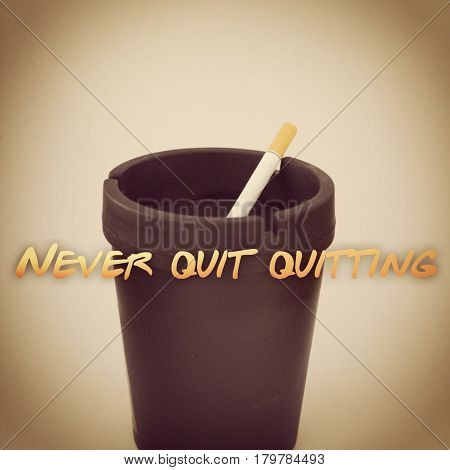 Cigarette in black ashtray isolated on white background with effects and text. Never quit quitting.