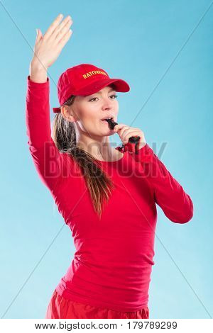 Lifeguard Woman In Cap On Duty Blowing Whistle.