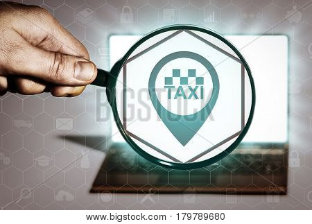 Hand holds the magnifying glass in front of an open notebook. Among the many icons attention is focused on the taxi icon. Search taxi service.