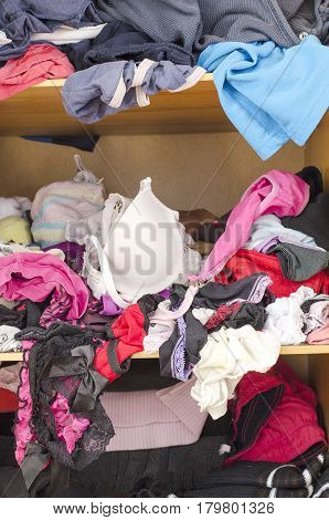Pile Of Carelessly Scattered Clothes In Wardrobe