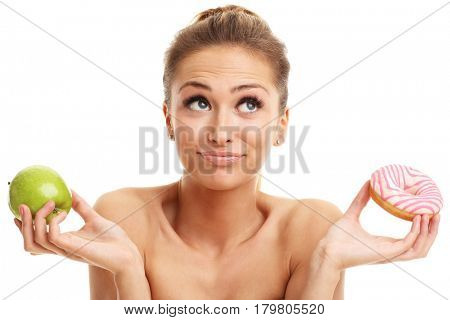 Adult woman posing with donuts over white background