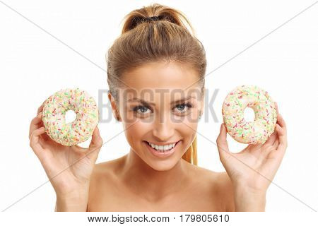 Adult woman posing with donuts over white background