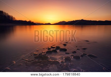 Beautiful sunrise on lake Liptovska Mara Slovakia. Long exposure shot with ND filter