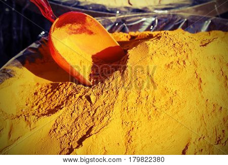 Turmeric Curry Powder Background And A Red Bailer