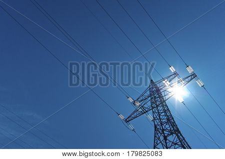 electricity pylon with sun and sky