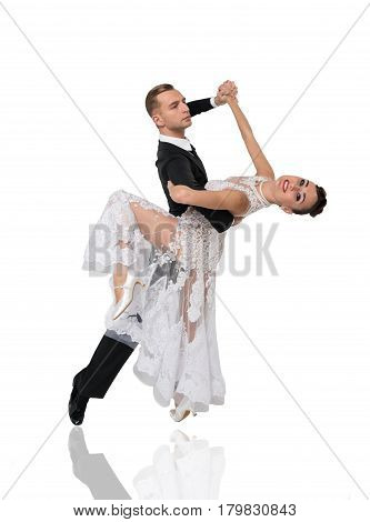beautiful ballroom dance couple in a dance pose isolated on white background. sensual professional dancers dancing walz tango slowfox and quickstep