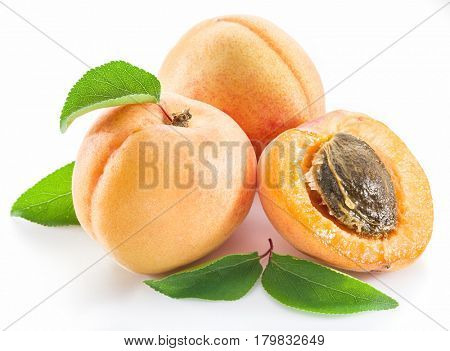 Apricots and its cross-section on the white background.