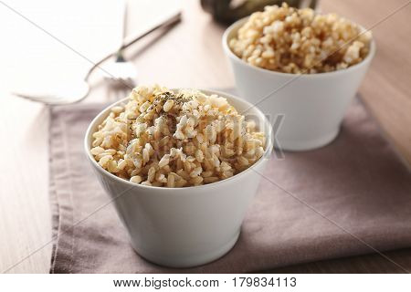 Two bowls of brown rice on napkin