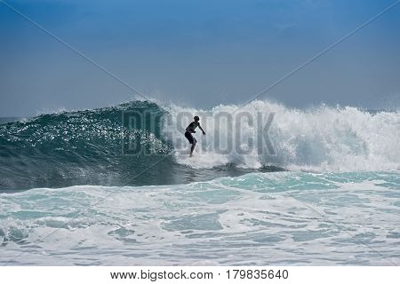 PUERT VIEJO, COSTA RICA-MARCH 19, 2017: Surfer on the beach near Puerto Viejo, Costa Rica