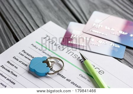 Travel preparation concept with insurance application form and credit cards for online payment on wooden table background