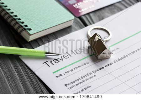 Traveling concept with insurance application form and credit cards on gray wooden table background