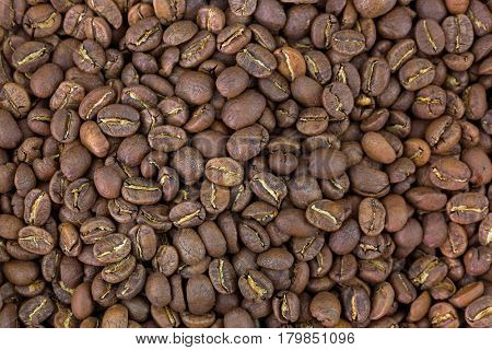 Closeup texture of very dark brown roasted coffee beans. Costa Rica La Rosalia mixed with Kenya Kiawamururu AB coffeebeans