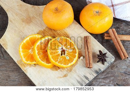 Ripe oranges sliced on oid wood background. Orange in a cut.