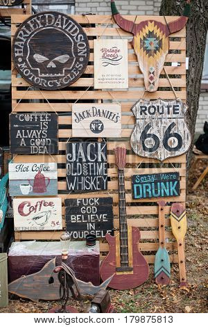 Kyiv city, Ukraine - September 10, 2016 : Vintage wooden boardes, old signs posters with motivational phrases hang on the wall