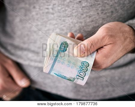 Hands hold russian rubles. Selective focus. Shallow DOF